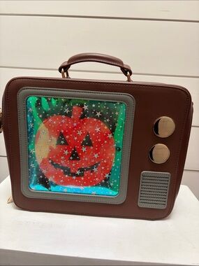 Backstitch Bruja Brown Crossbody Bag with Pumpkin TV screen.